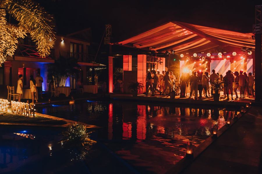 Pista de dança iluminada de vermelho à beira da piscina